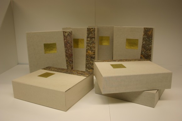 The handmade protective boxes housing the scrapbooks. 